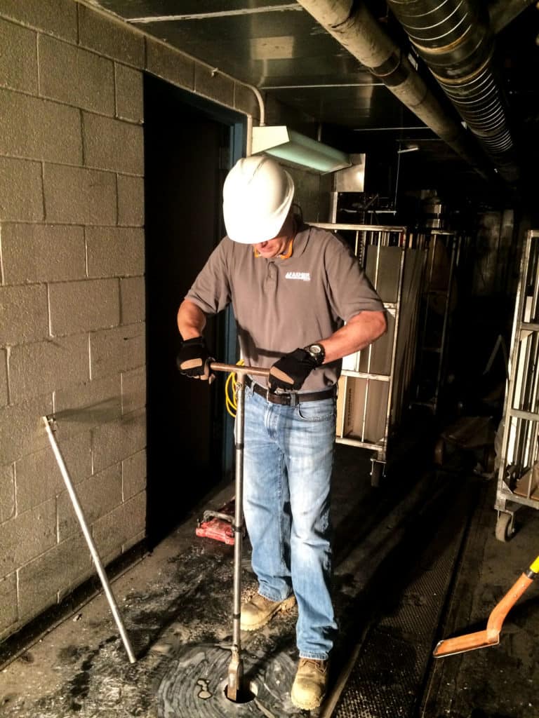 Farmer EG at work inside a building with pipes